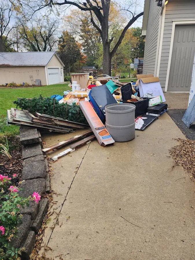 Dumpster being loaded with debris for Roofing Dumpster Rental in Sodus